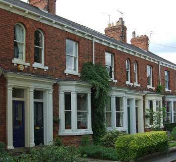 A terrace  of Victorian homes featuring sash bay window but bay is only on ground floor